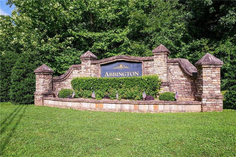 Community / neighborhood sign featuring a lawn