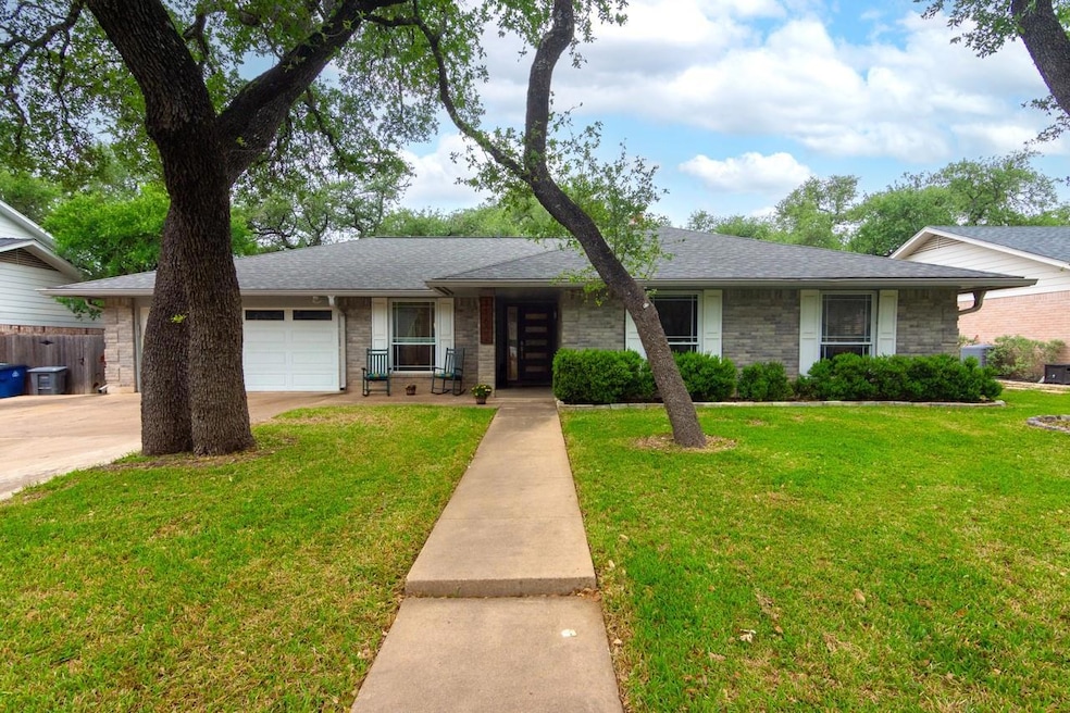 View of front of home with an attached garage, st