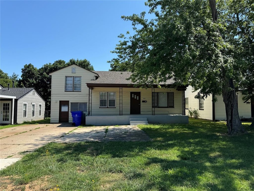 Tri-level home with a garage and a front lawn