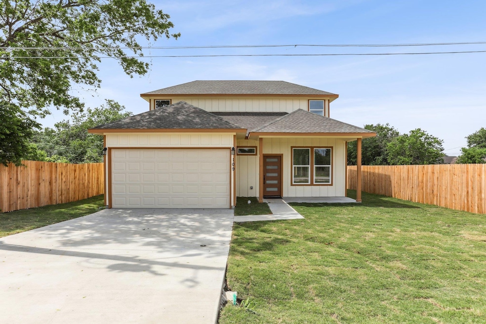 View of front facade with fence, a shingled roof,