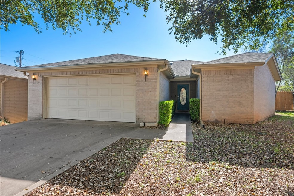 View of front of home with driveway, an attached g
