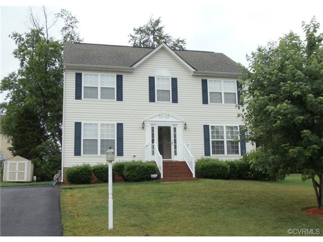 Landscaped with lawn and shade trees front and bac