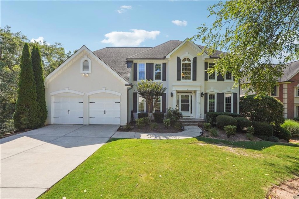 View of front of home with a garage and a front la