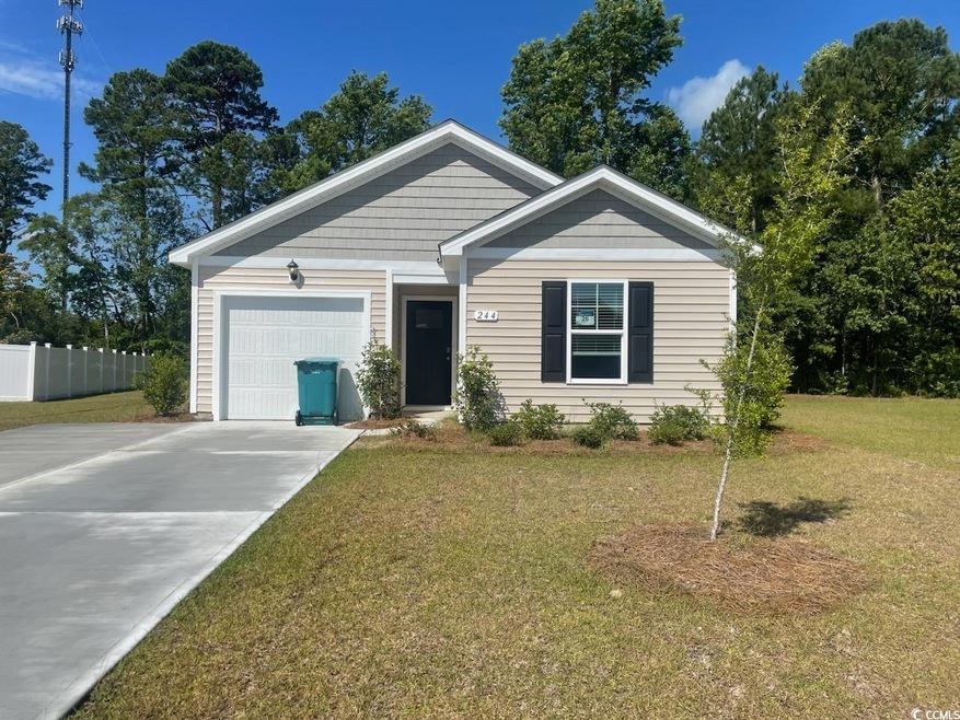 View of front facade with a garage and a front law