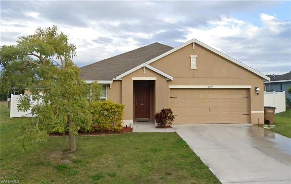 Ranch-style house featuring a garage, concrete dri