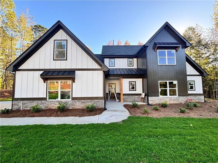 Modern inspired farmhouse featuring a front lawn