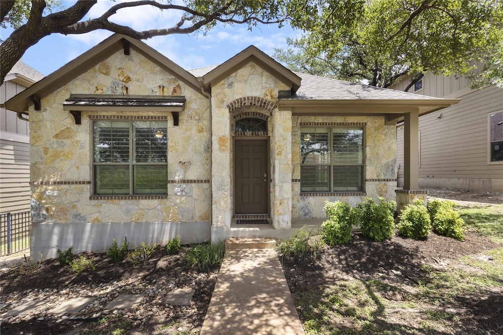 Entrance to property with stone siding and roof w