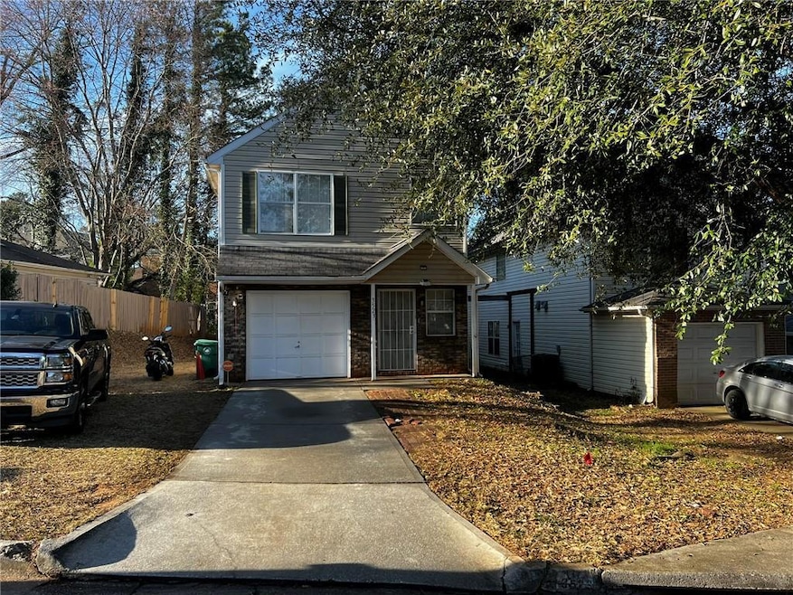 Traditional-style home featuring concrete driveway