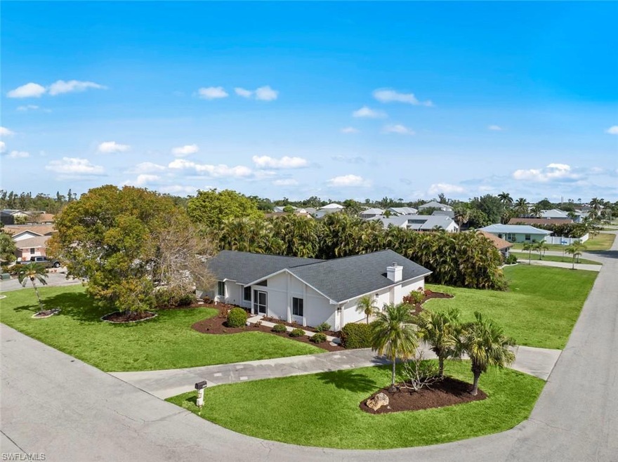 Single story home with a yard, a shingled roof, and stucco siding
