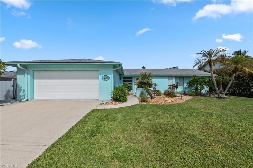 Single story home with a garage and a front lawn