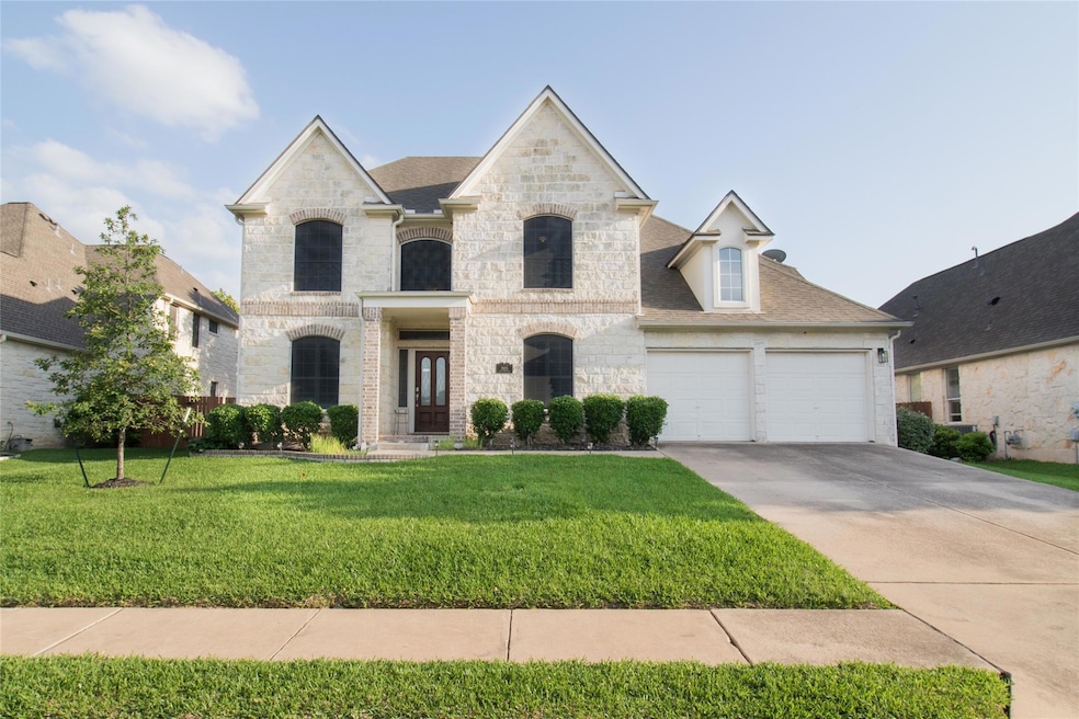 French country inspired facade with stone siding,