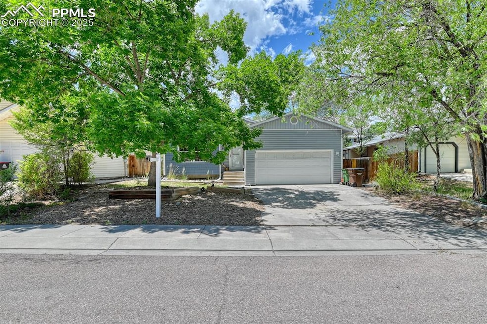 Obstructed view of property featuring concrete driveway and an attached garage