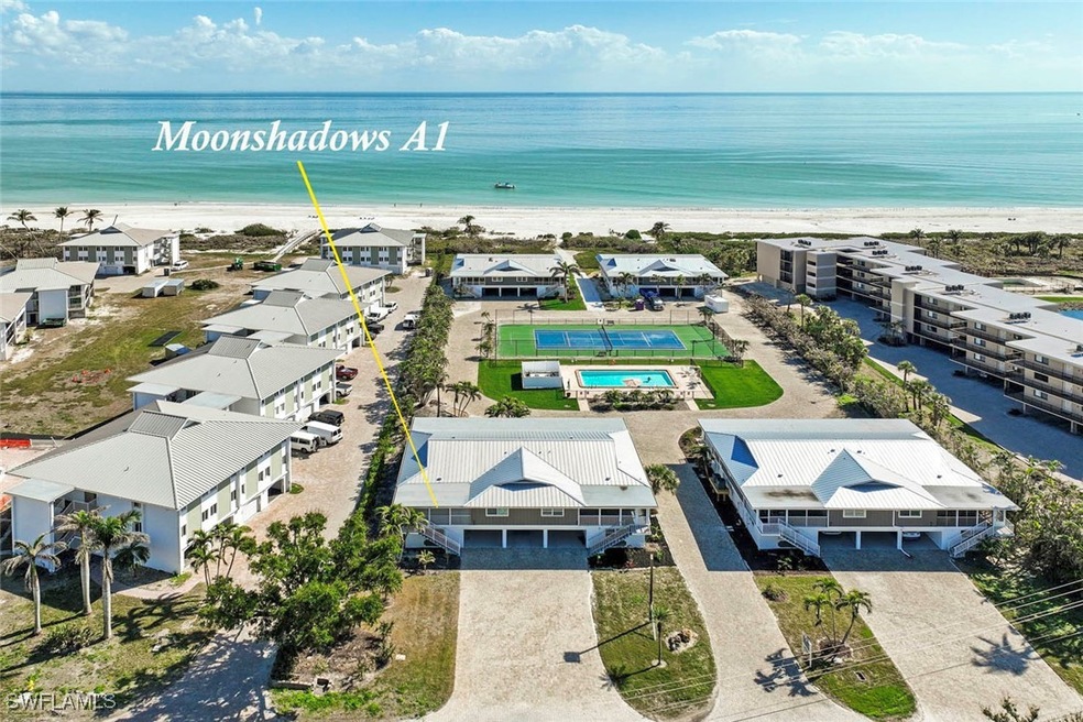 Aerial view featuring a water view and a beach vie