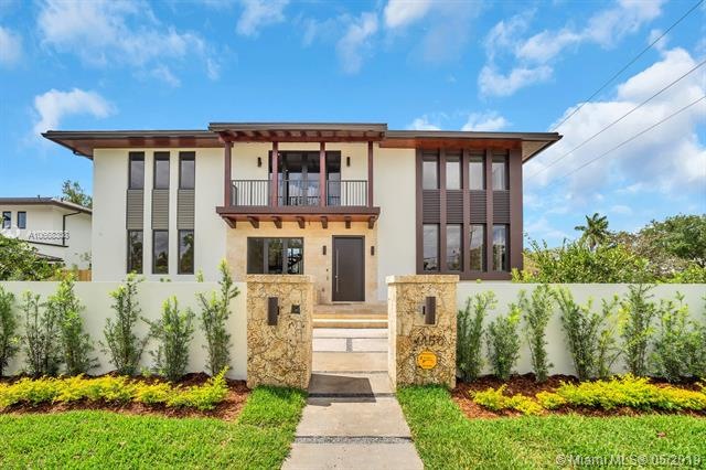 View of front entrance from outside wall and gate. House faces north