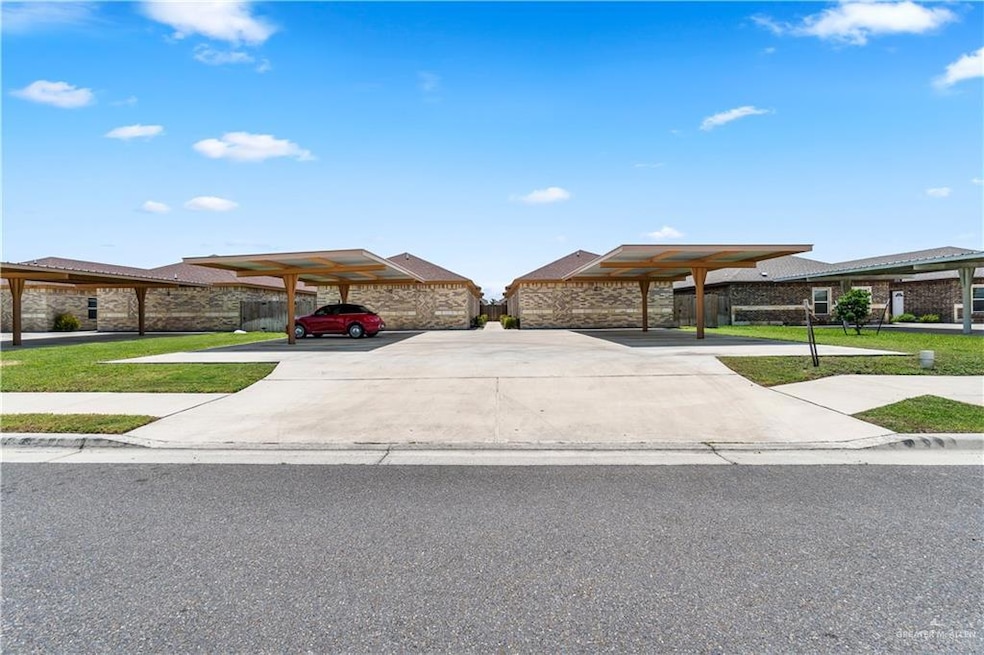 View of front of home featuring a carport and a front lawn