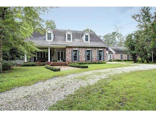 Photo. Brick porch with french doors, gas lanterns