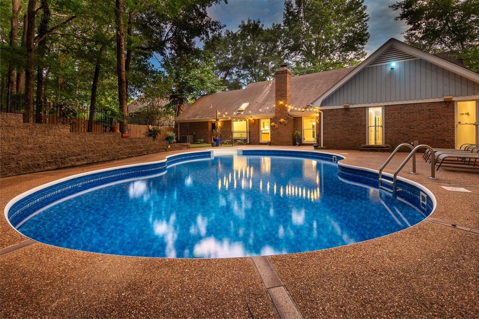 Pool at dusk with a patio area