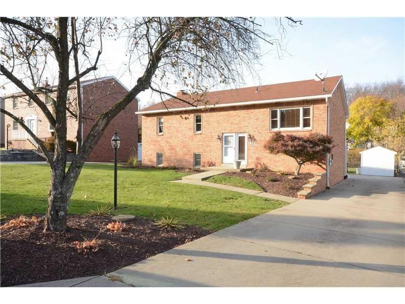 Exterior Front. Custom all brick split entry home,