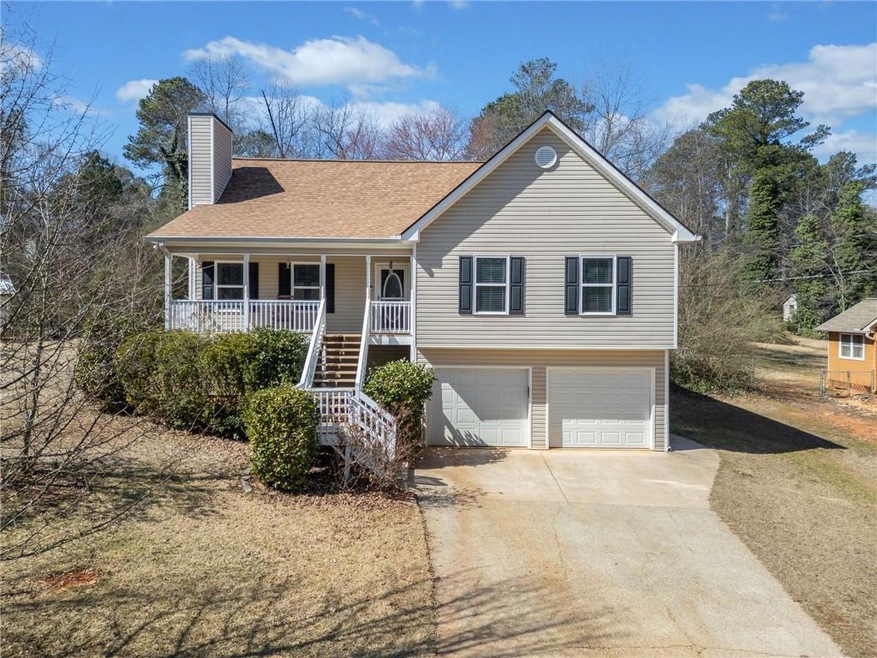 View of front of house with concrete driveway, a c