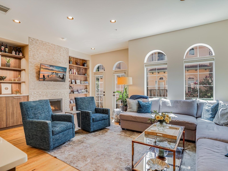 Living room featuring built in shelves, light woo
