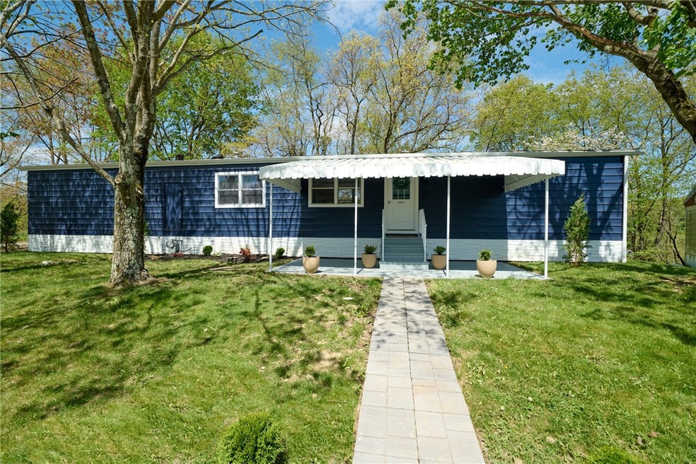 Lanscaped front yard and covered porch.