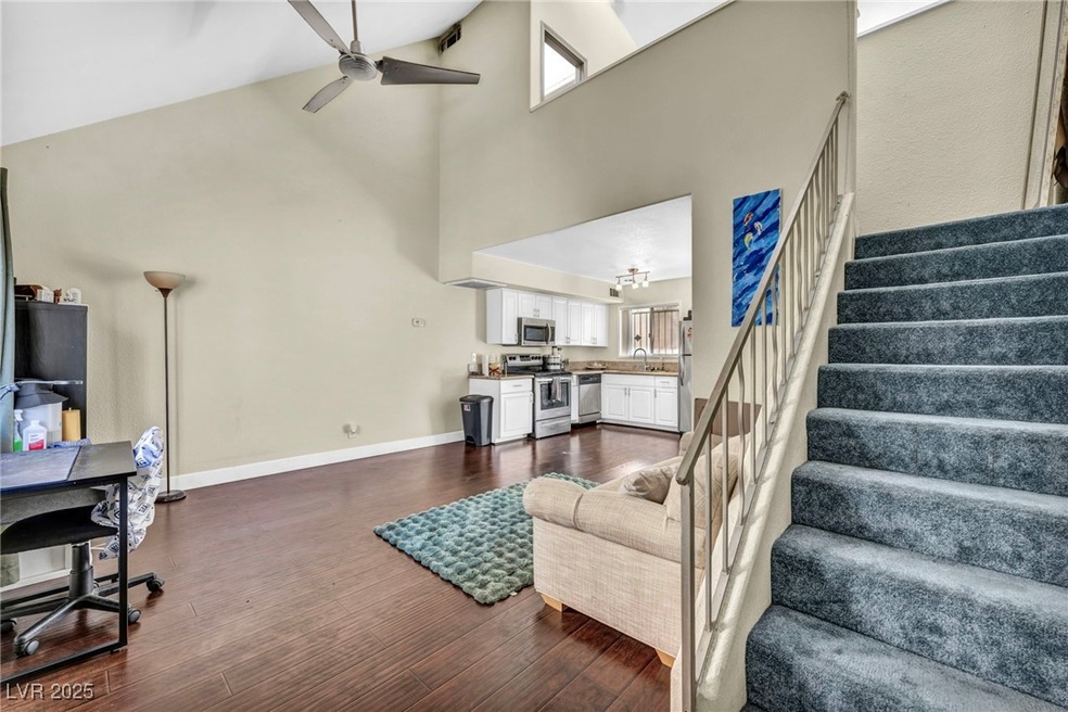 Living room with high vaulted ceiling, dark wood f