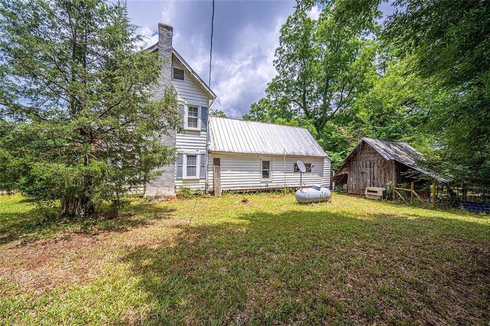 Rear view of house featuring a lawn