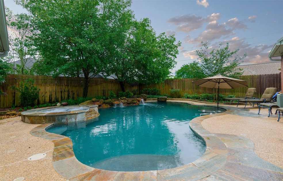 Just in time for summer the backyard features a gorgeous pool with a  hot tub, rock water fall, a rock 