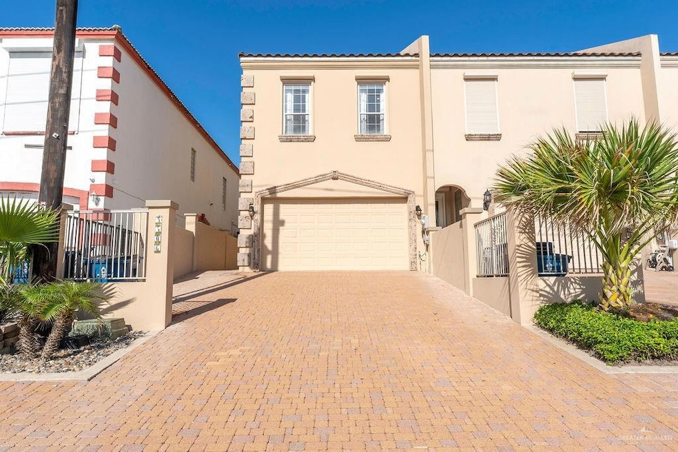 Mediterranean / spanish-style house featuring stucco siding, an attached garage, decorative driveway, a gate, and a tiled roof