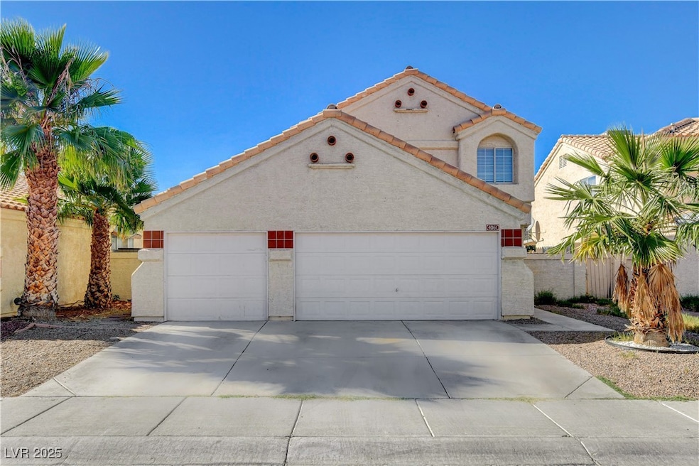 Mediterranean / spanish home featuring driveway, stucco siding, a tiled roof, and an attached garage