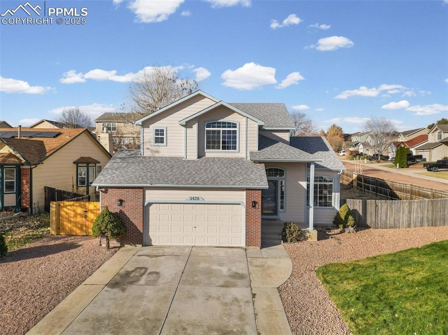 2 Story home featuring roof with shingles, a garage, concrete driveway, and brick siding