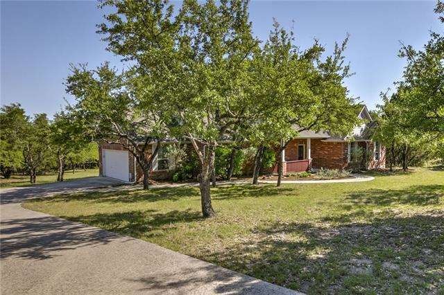 Hidden in the oak trees and 3 sides brick exterior