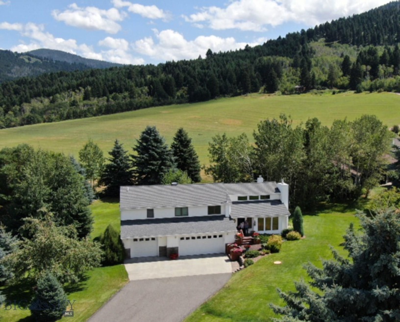 Over 1/2 an acre filled with trees, green grass an