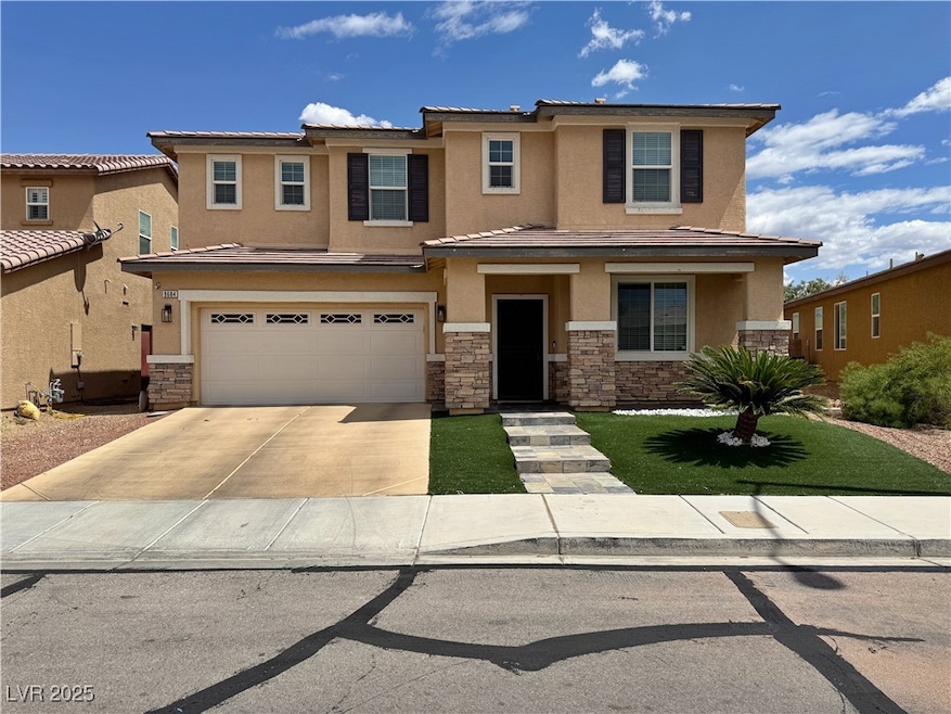 View of front of property with stucco siding, driv