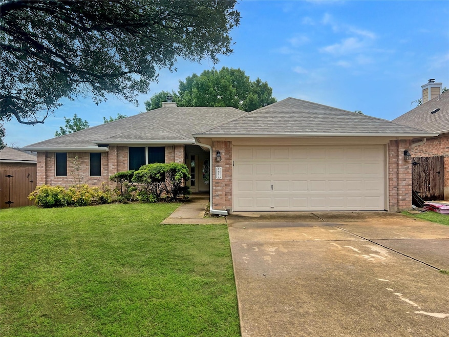 Single story home with a shingled roof, driveway,