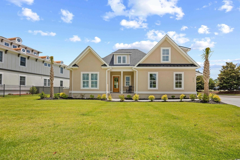View of front of house with stucco siding, a porch, and a standing seam roof