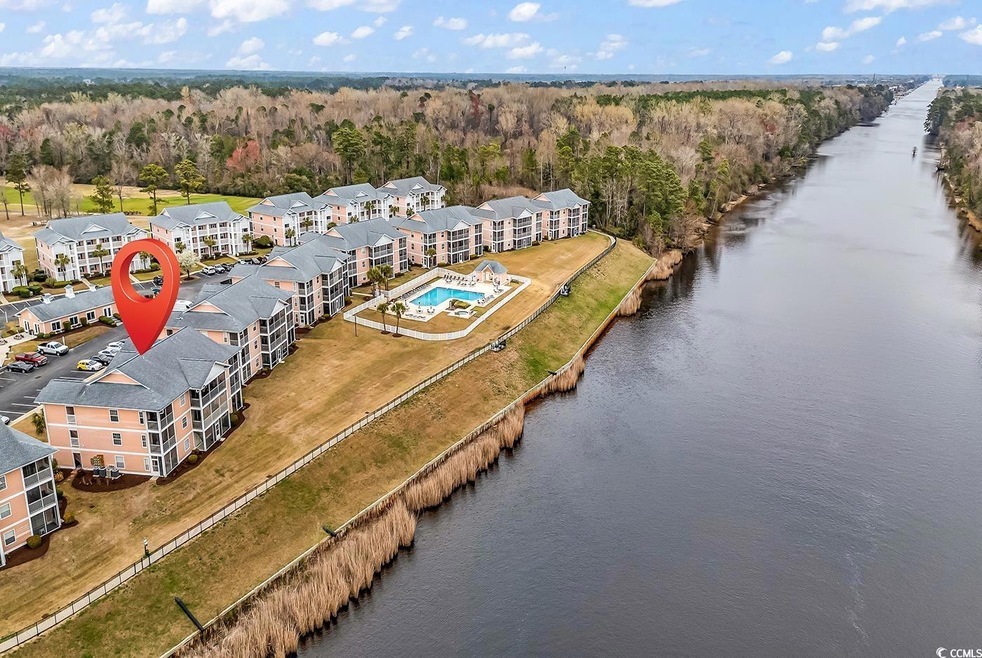 Drone / aerial view featuring a wooded view and a water view