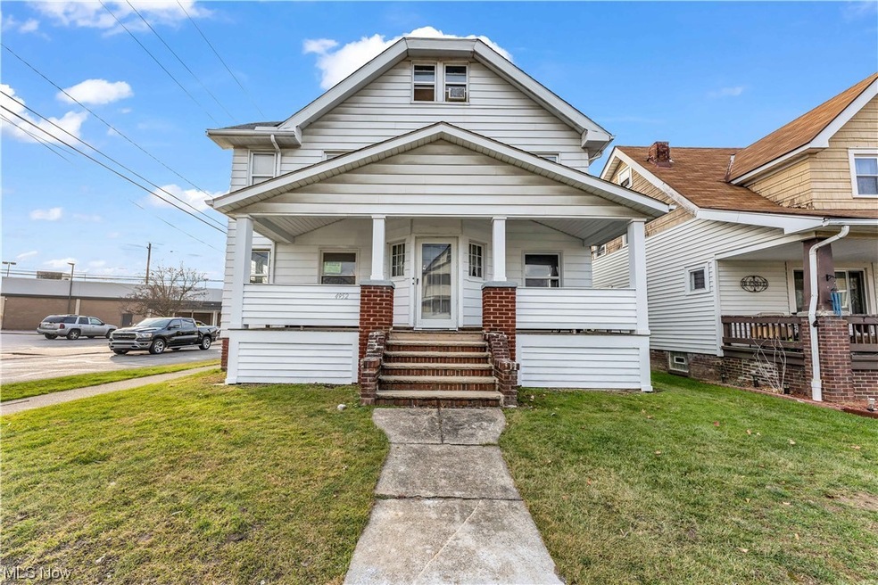 Bungalow featuring a front lawn and covered porch