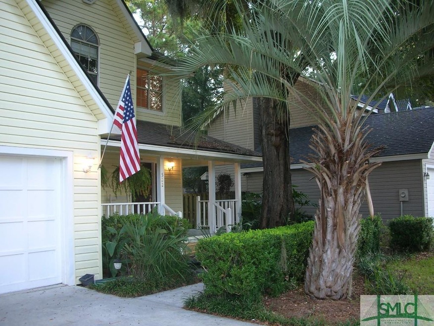 Low Country Porch with mature landscaping invites 