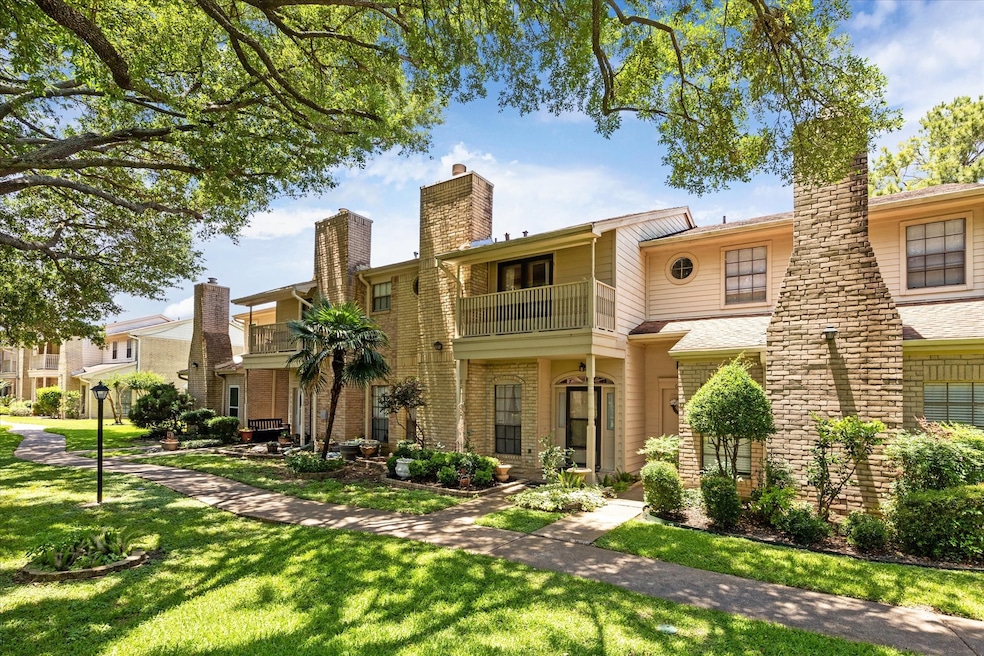 This photo shows a charming two-story townhouse wi