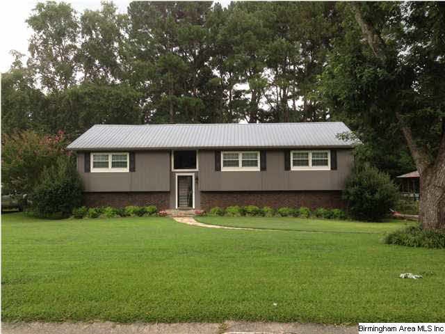 Front view of home with large level yard