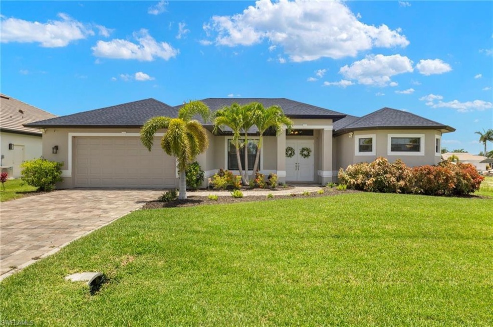 View of front of house featuring a garage and a front lawn