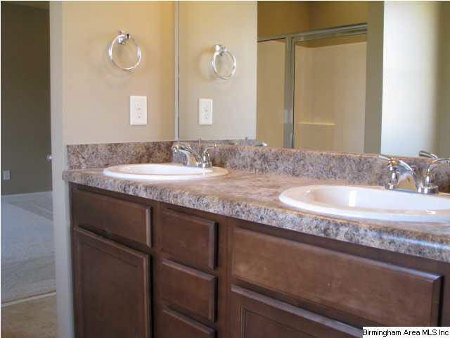 Master bath has raised vanity with 2 sinks.
