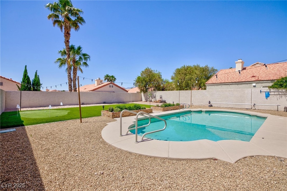 View of pool with a fenced backyard, a patio area,