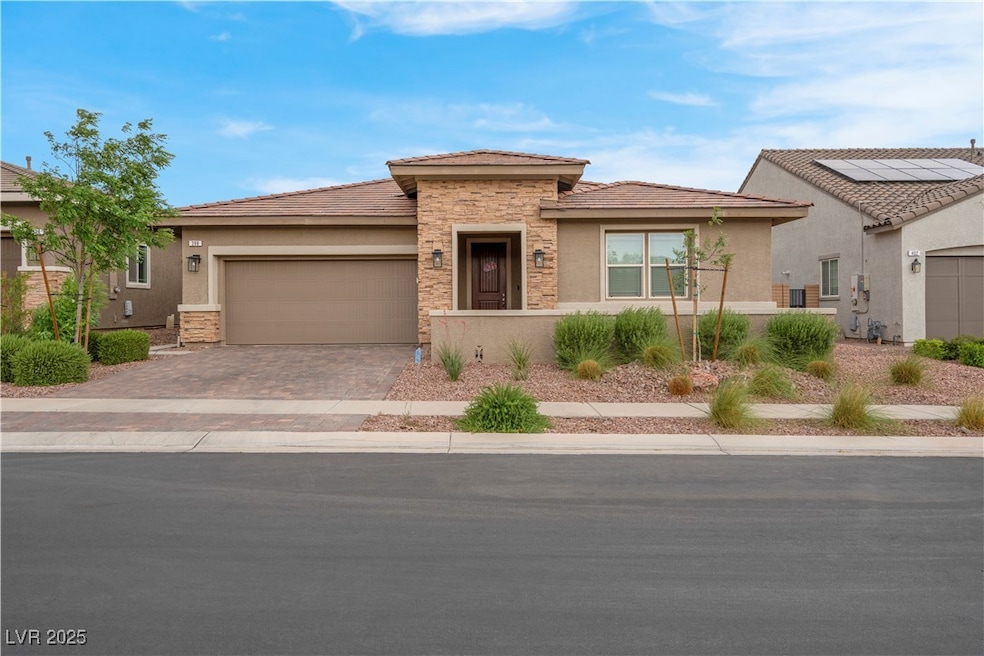 View of front facade featuring stucco siding, ston