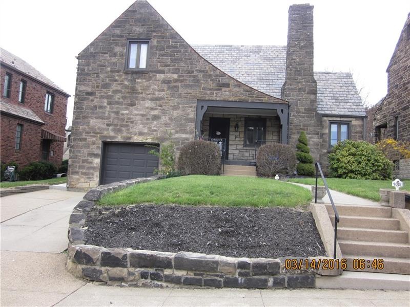 Stunning Stone Tudor with large front porch, doubl