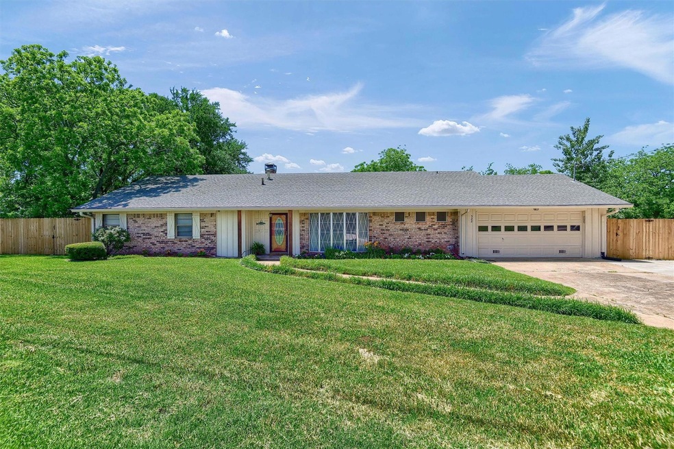 Single story home with a garage and a front yard