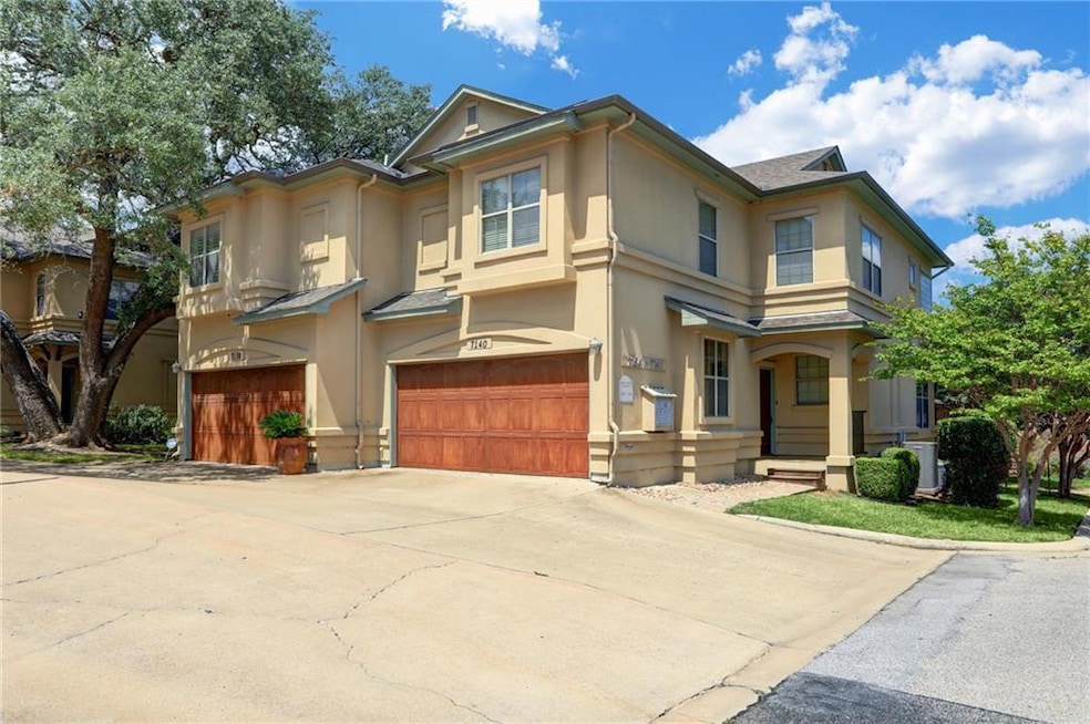 View of front of house featuring stucco siding, a