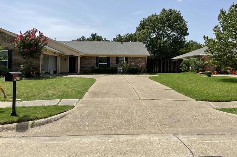 Ranch-style home with a front yard
