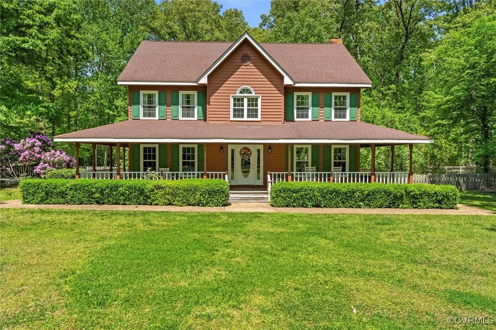View of front of home with a porch, a chimney, a s